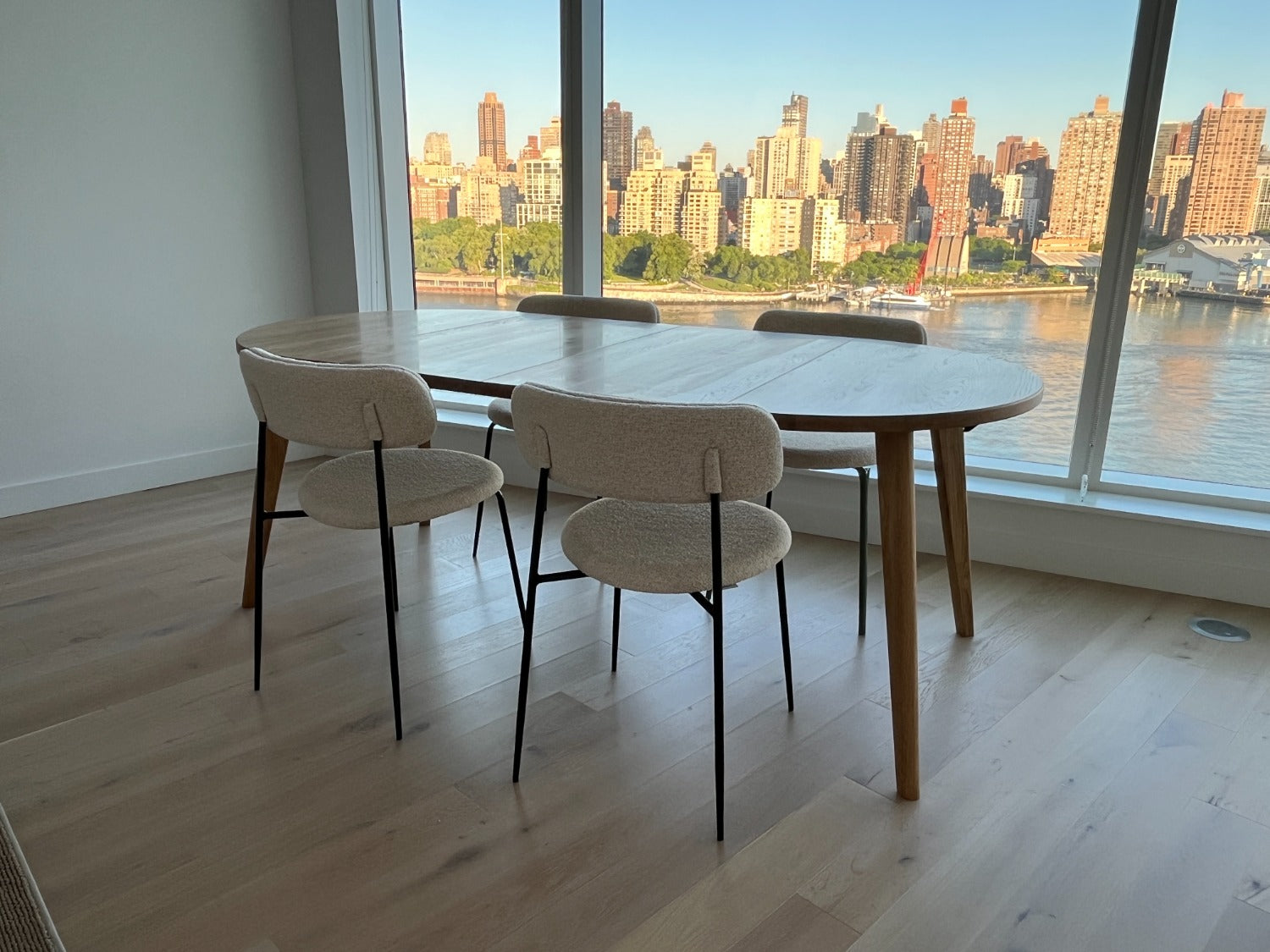 Extendable round oak dining table, Oakwell collection, in New York apartment